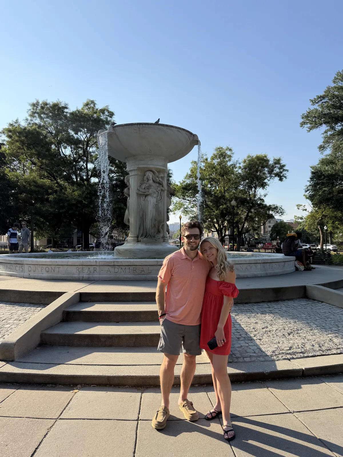 Kaitlyn and Jack in front of the Dupont Circle fountain on a sunny day
